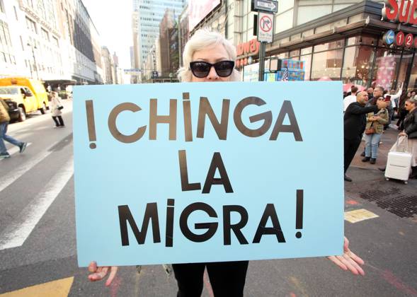 October 18, 2025, New York City, New York, USA: A woman holds a sign that says in Spanish, Chinga La Migra during the No Kings protest in New York City on Oct. 18, 2025. Tens of thousands of people hit New York City streets to protest Donald Trump, autocracy, ICE and immigrant deportations. More than 2,500 similar protests took place nationwide. New York City USA - ZUMAk45_ 20251018_zaf_k45_056 Copyright: xKristaxKennellx