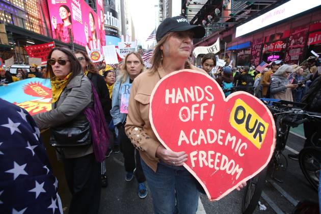 October 18, 2025, New York City, New York, USA: A woman holds a sign that says, Hands Off! Our Academic Freedom during the No Kings protest in New York City on Oct. 18, 2025. Tens of thousands of people hit New York City streets to protest Donald Trump, autocracy, ICE and immigrant deportations. More than 2,500 similar protests took place nationwide. New York City USA - ZUMAk45_ 20251018_zaf_k45_059 Copyright: xKristaxKennellx