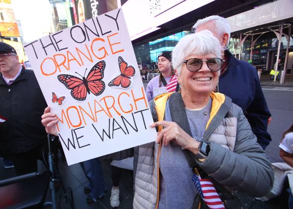 October 18, 2025, New York City, New York, USA: A woman holds a sign during a No KIngs protest in New York City on Oct. 18, 2025. Tens of thousands of people hit New York City streets to protest Donald Trump, autocracy, ICE and immigrant deportations. More than 2,500 similar protests took place nationwide. New York City USA - ZUMAk45_ 20251018_zaf_k45_069 Copyright: xKristaxKennellx