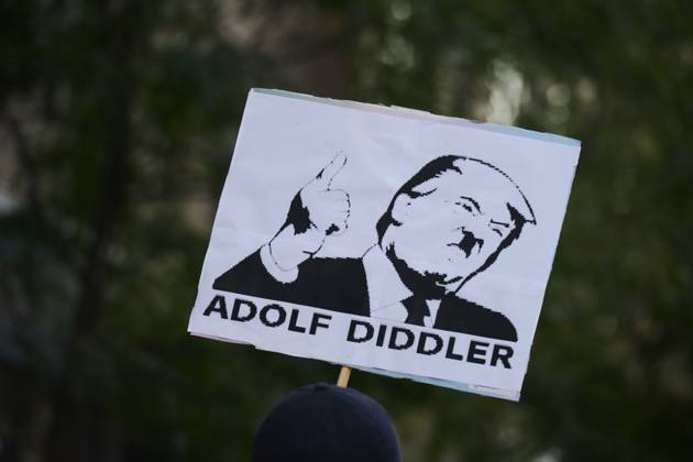 October 18, 2025, New York, New York, USA: Protester holds a sign with an image of Donald Trump with a Hitler style mustache that reads, â€oeAdolf Diddler†in the New York City No Kings protest in opposition to measures Donald Trump has taken to install authoritarian style rule. New York USA - ZUMAl171 20251018_znp_l171_031 Copyright: xEdnaxLeshowitzx
