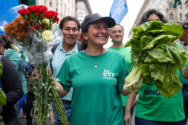 October 16, 2025, Buenos Aires, Buenos Aires, Argentina: A Farmer Poses Holding Flowers and Vegetables. On the march to Plaza de Mayo, she carries fresh food as a symbol of protest against the production and consumption crisis. Buenos Aires Argentina - ZUMAp265 20251016_zip_p265_001 Copyright: xDelfinaxCorberaxPix