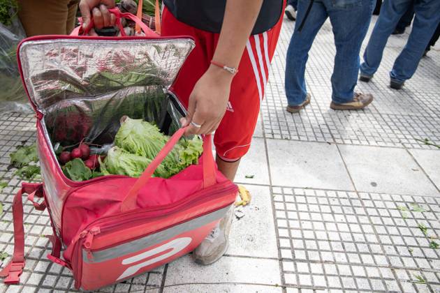 October 16, 2025, Buenos Aires, Buenos Aires, Argentina: A Delivery Worker Packs Food into His Backpack.During the farmersâ€⠢ protest at Plaza de Mayo, fresh produce is freely distributed to spotlight the sectorâ€⠢s production and consumption crisis. Buenos Aires Argentina - ZUMAp265 20251016_zip_p265_012 Copyright: xDelfinaxCorberaxPix