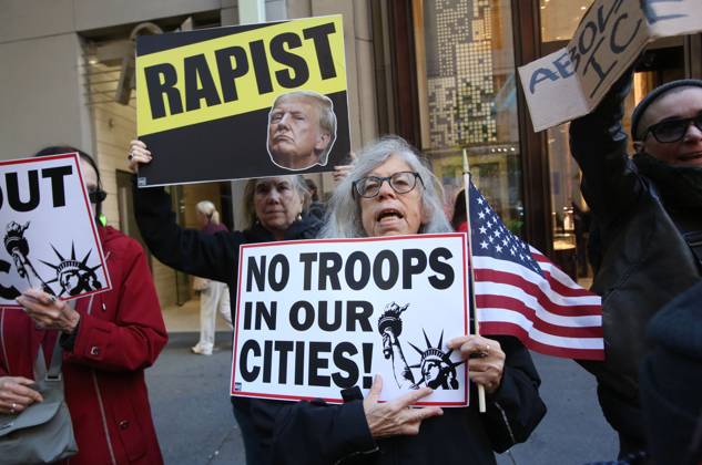 October 25, 2025, New York City, New York, USA: A woman holds a sign that says No Troops in our Cities during a Hands Off NYC rally. outside of Trump Tower on October 25, 2025. Some women wore polka dots in honor of a protestor who confronted ICE agents and tank vehicles. The peaceful rally drew a handful of Trump supporters. New York City USA - ZUMAk45_ 20251025_zaf_k45_012 Copyright: xKristaxKennellx