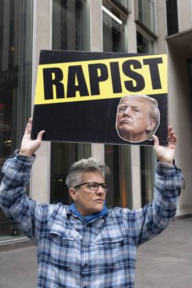 October 28, 2025, New York, New York, USA: A demonstrator holds a sign that reads RAPIST with an image of President Trump, joining peaceful protesters outside of News Corp s Fox News Channel in midtown Manhattan. People with the activist groups Rise & Resist and Truth Tuesdays call for truth in journalism and denounce ICE, Federal troops sent to cities and Fox News as extremist right-wing propaganda in support of President Trump s administration. New York USA - ZUMAr174 20251028_znp_r174_026 Copyright: xGinaxMxRandazzox