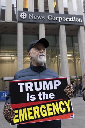 October 28, 2025, New York, New York, USA: A demonstrator holds a sign that reads TRUMP is the EMERGENCY joining peaceful protesters outside of News Corp s Fox News Channel in midtown Manhattan. People with the activist groups Rise & Resist and Truth Tuesdays call for truth in journalism and denounce ICE, Federal troops sent to cities and Fox News as extremist right-wing propaganda in support of President Trump s administration. New York USA - ZUMAr174 20251028_znp_r174_028 Copyright: xGinaxMxRandazzox