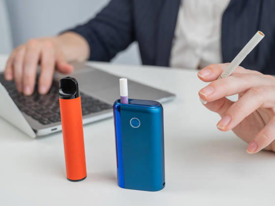 A woman demonstrates different types of cigarettes. An e-cigarette, a disposable vape, and a regular cigarette. A woman demonstrates different types of cigarettes. An e-cigarette, a disposable vape, and a regular cigarette, model released, , 97688556.jpg RECORD DATE NOT STATED
