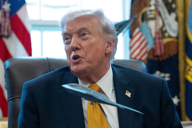President Donald Trump gives remarks with a model stealth bomber on the Resolute Desk during an Executive Order signing event in the Oval Office of the White House in Washington, DC on Monday, March 16, 2026. The order will formally launch a task force, led by Vice President JD Vance, to investigate fraud nationwide. WAP20260316077 AARONxSCHWARTZ