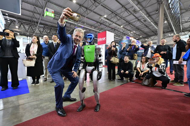 Czech Senate President Milos Vystrcil takes a selfie with a humanoid robot at opening of the 67th International Engineering Fair, which begins at Vystaviste 1 exhibition grounds in Brno, Czech Republic, on October 6th, 2026. International Fair of Machine Tools and Forming Machines IMT, International Welding Engineering Fair Welding, International Fair of Plastics, Rubber and Composites Plastex, International Fair of Surface Treatment Technologies Profintech and International Foundry Fair Fond-Ex also start. (CTKxPhoto VaclavxSalek) CTKPhotoP2026100603482 CTKPhotoP2026100603482