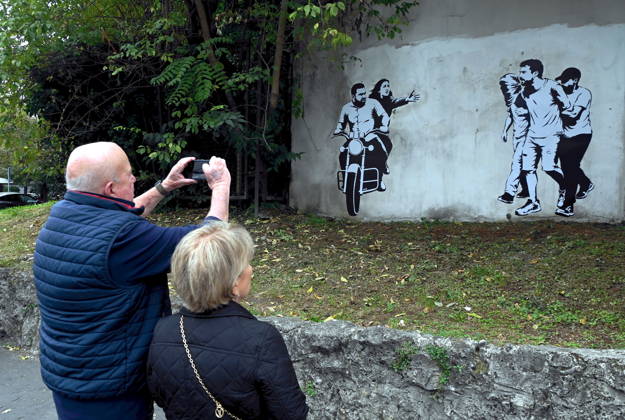 IPA89393692 - MILAN - October 7, 2026 - A mural by Alexandro Palombo, an artwork on display on October 7 at the Museum of Modern Art, located at 16 Via Palestro, dedicated to the young couple kidnapped during the attack on the Nova Music Festival Copyright: xMaurizioxMaulex xMaurizioxMaulex IPA89393692