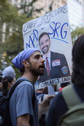 October 7, 2026, New York, New York, USA: A demonstrator wearing a keffiyeh holds a protest sign during a pro-Palestinian rally at City Hall Park in New York City, New York. New York USA - ZUMAs237 20261007_aap_s237_024 Copyright: xMarkxJ.xSullivanx