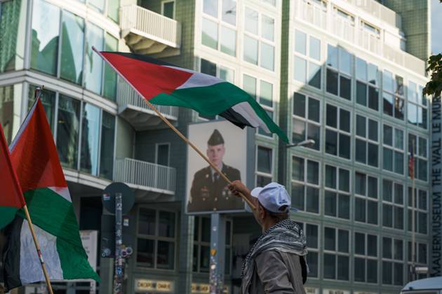 October 7, 2026, Berlin, Berlin, Germany: BERLIN, GERMANY, OCTOBER 7, 2026: Demonstrators gather at Checkpoint Charlie in central Berlin to mark three years since the start of the Gaza war. Participants protest against Israelâ€⠢s military actions in Gaza, which they describe as genocide, and express solidarity with Palestinians. Berlin Germany - ZUMAq101 20261007_zna_q101_406 Copyright: xNikosxKanistrasx