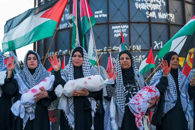 October 7, 2026, Berlin, Berlin, Germany: BERLIN, GERMANY, OCTOBER 7, 2026: Demonstrators gather at Checkpoint Charlie in central Berlin to mark three years since the start of the Gaza war. Participants protest against Israelâ€⠢s military actions in Gaza, which they describe as genocide, and express solidarity with Palestinians. Berlin Germany - ZUMAq101 20261007_zna_q101_413 Copyright: xNikosxKanistrasx