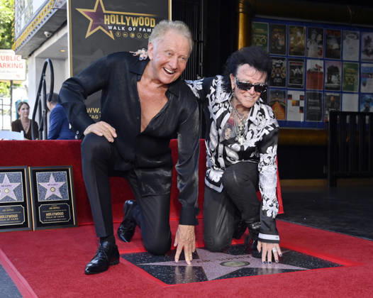 Graham Russell (L) and Russell Hitchcock of the rock duo Air Supply kneel next to their star during an unveiling ceremony honoring them with the 2,859th star on the Hollywood Walk of Fame in Los Angeles on Thursday October 8, 2026.  LAP2026100810 JIMxRUYMEN