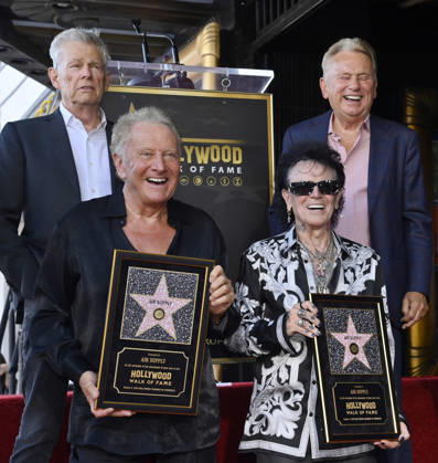 Graham Russel (L) and Russell Hitchcock of the rock duo Air Supply hold replica plaques during during an unveiling ceremony honoring them with the 2,859th star on the Hollywood Walk of Fame in Los Angeles on Thursday October 8, 2026. Looking on is David Foster (L) and Pat Sajak  LAP2026100804 JIMxRUYMEN