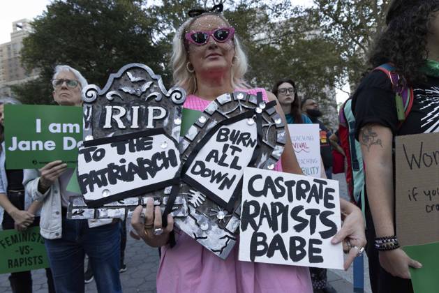 October 8, 2026, New York, New York, USA: A demonstrator holds signs that read RIP TO THE PATRIARCH BURN IT ALL DOWN CASTRATE RAPISTS BABE joining hundreds at a rally in Foley Square outside the New York State Supreme Court building in Lower Manhattan under the banner . StopSexualViolence: From the Frat House to the White House. The protest is one of many rallies and campus walkouts around the country demanding justice for Cornell s Jane Doe. New York USA - ZUMAr174 20261008_znp_r174_022 Copyright: xGinaxMxRandazzox
