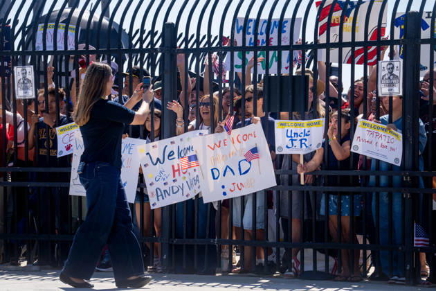 October 8, 2026, Coronado, California, United States: Family members and supporters gather behind a gate holding welcome-home signs as the aircraft carrier USS Abraham Lincoln (CVN 72) returns to Naval Air Station North Island in Coronado, California, on October 8, 2026, following a deployment. Coronado United States - ZUMAg374 20261008_znp_g374_006 Copyright: xLoganxGrahamx