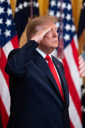 President Donald Trump salutes during the National Anthem during an event in the East Room of the White House in Washington, DC on Friday, Oct. 9, 2026. Trump is hosting a Columbus Day celebration.  WASP20261009112 AaronxSchwartz