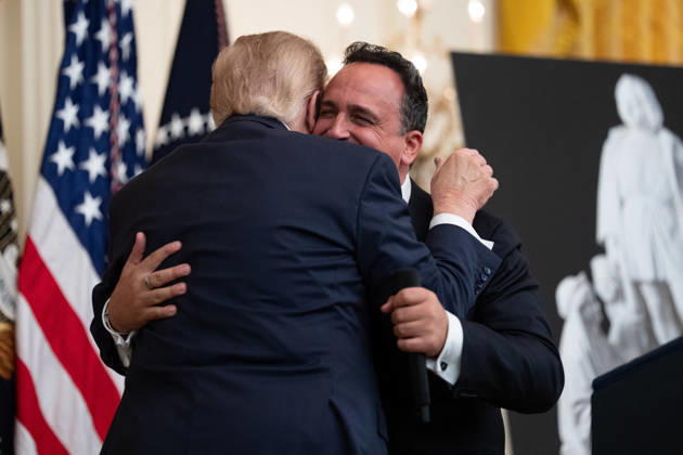 US President Donald Trump Gives Remarks - Washington DC US President Donald Trump embraces singer Christopher Macchio during an event in the East Room of the White House in Washington, DC, US, on Friday, Oct. 9, 2026. Trump is hosting a Columbus Day celebration. Photo by Aaron Schwartz Pool ABACAPRESS.COM Washington District of Columbia Copyright: xPool ABACAx