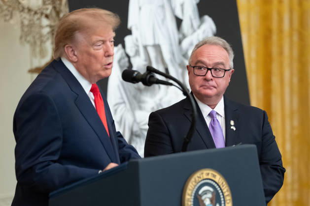 Brett Rugo, founder of Rugo Stone which constructed a helipad on the South Lawn, looks on as President Donald Trump speaks during an event in the East Room of the White House in Washington, DC on Friday, Oct. 9, 2026. Trump is hosting a Columbus Day celebration. WASP20261009116 AaronxSchwartz