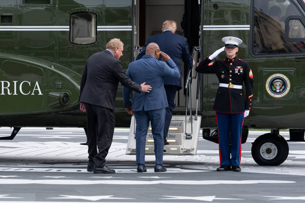 President Donald Trump and president of the New York yankees Randy Levine board Marine One as former professional boxer Mike Tyson salutes a marine in Washington, DC on Friday, Oct. 9, 2026. Trump is heading to Syracuse on Friday to boost Republican gubernatorial candidate Bruce Blakeman, who is trailing Governor Kathy Hochul in polls ahead of November s election.  WASP20261009157 AaronxSchwartz