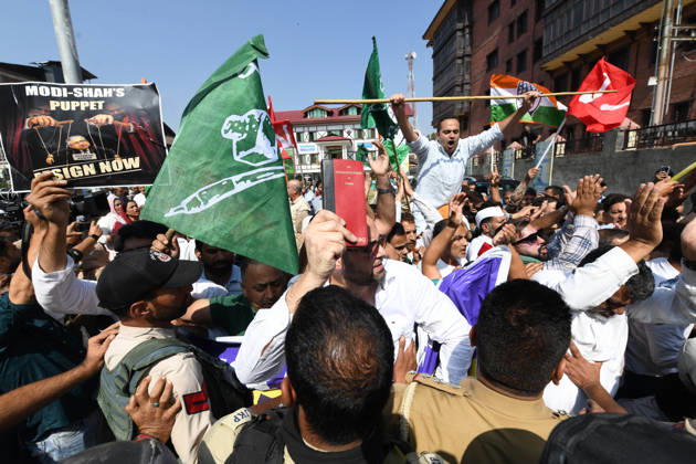 October 10, 2026, Srinagar, Jammu And Kashmir, India: Police personnel try to stop supporters of the opposition alliance INDIA bloc (Indian National Developmental Inclusive Alliance) during a protest demanding the resignation of India s Chief Election Commissioner Gyanesh Kumar over alleged voter roll irregularities linked to the special intensive revision (SIR), in Srinagar on October 10, 2026. Srinagar India  - ZUMAz120 20261010_zip_z120_014 Copyright: xBasitxZargarx