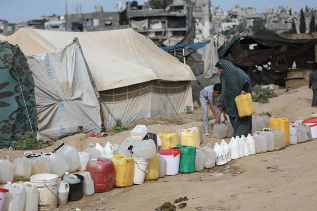 Palestinians still lack basic necessities amid Israel attacks DEIR AL BALAH, GAZA, PALESTINE - OCTOBER 10: Palestinians living in tents set up in the Bureij area carry water in containers to their makeshift shelters in Deir al Balah, Gaza, Palestine on October 10, 2026.The humanitarian crisis in the region continues to deepen, with thousands of displaced families struggling to survive without access to the most basic necessities. Adam Bilal Anadolu Deir al Balah Gaza. Editorial use only. Please get in touch for any other usage.  Copyright: x2026xAnadoluxAdamxBilalx