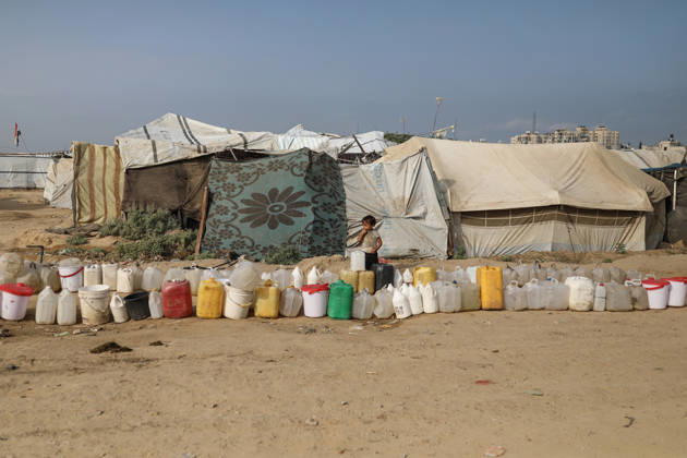 Palestinians still lack basic necessities amid Israel attacks DEIR AL BALAH, GAZA, PALESTINE - OCTOBER 10: Palestinians living in tents set up in the Bureij area carry water in containers to their makeshift shelters in Deir al Balah, Gaza, Palestine on October 10, 2026.The humanitarian crisis in the region continues to deepen, with thousands of displaced families struggling to survive without access to the most basic necessities. Adam Bilal Anadolu Deir al Balah Gaza. Editorial use only. Please get in touch for any other usage.  Copyright: x2026xAnadoluxAdamxBilalx