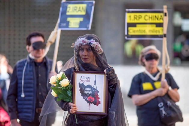 October 10, 2026, Madrid, Spain: A woman holds a portrait with a veil on her head, during a rally against the death penalty in Callao Square in central Madrid. World Day Against the Death Penalty has been observed every October 10th since 2003. Madrid Spain  - ZUMAs197 20261010_aaa_s197_024 Copyright: xLuisxSotox
