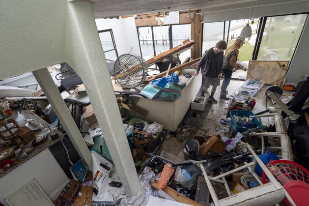 October 10, 2026, Pensacola Beach, Fl, USA: Laura and Alex Dean clean out their home that was severely damaged during Hurricane Isaias..Hurricane Isaias made landfall Friday, October 9 along the U.S. Gulf coast. Pensacola Beach USA  - ZUMAs197 20261010_aaa_s197_037 Copyright: xJenxGolbeckx