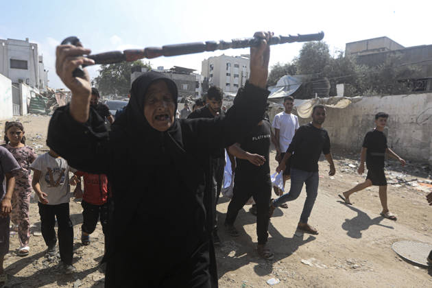 Gaza Palestine Airstrike Aftermath An elderly woman walks ahead of mourners carrying a shrouded body in Gaza City, Palestine on October 10, 2026. Four Palestinians were killed in an air strike near Panda Mall, and people carried the victims toward Al-Shifa Hospital for funeral prayers. Gaza Gaza Strip Palestinian Territories Copyright: xIbrahimxZanounx
