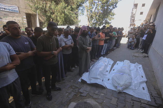 Gaza Palestine Airstrike Aftermath Mourners perform prayers a shrouded body outside Al-Shifa Hospital in Gaza City, Palestine on October 10, 2026. Four Palestinians were killed in an air strike near Panda Mall, and people carried the victims toward Al-Shifa Hospital for funeral prayers. Gaza Gaza Strip Palestinian Territories Copyright: xIbrahimxZanounx