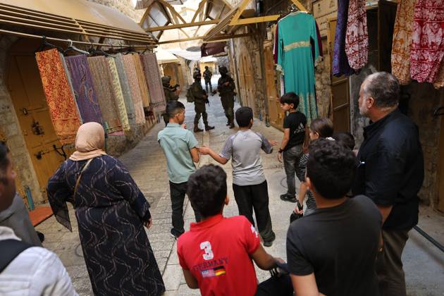 Israeli settlers enter Hebron Old City under military protection HEBRON, OCCUPIED WEST BANK, OCTOBER 10, 2026: Israeli settlers enter Hebron s Old City under the protection of Israeli forces during an organized visit to the area. Israeli soldiers deployed along streets and around the group as settlers moved through the Old City, where Israeli settlers and Palestinian residents live in close proximity amid longstanding tensions and movement restrictions. HEBRON Palestine, State of Copyright: x xMosabxshawerx xJNAxPressx