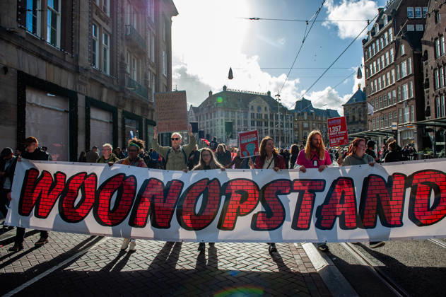 October 10, 2026, Amsterdam, North Holland, Netherlands: Protesters hold a banner expressing their opinion during the demonstration. People gathered against the worsening housing crisis. Under the motto Houses for people, not for profit, they demand fundamental changes in Dutch public housing. Amsterdam Netherlands  - ZUMAs197 20261010_aaa_s197_553 Copyright: xAnaxFernandezx
