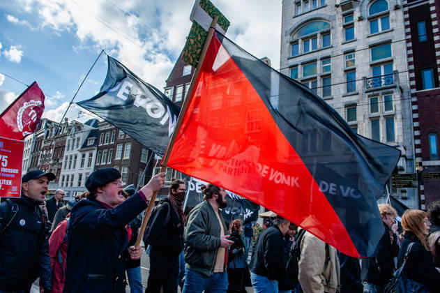 October 10, 2026, Amsterdam, North Holland, Netherlands: Protester are holding flags with the colors of anarchism during the demonstration. People gathered against the worsening housing crisis. Under the motto Houses for people, not for profit, they demand fundamental changes in Dutch public housing. Amsterdam Netherlands  - ZUMAs197 20261010_aaa_s197_560 Copyright: xAnaxFernandezx