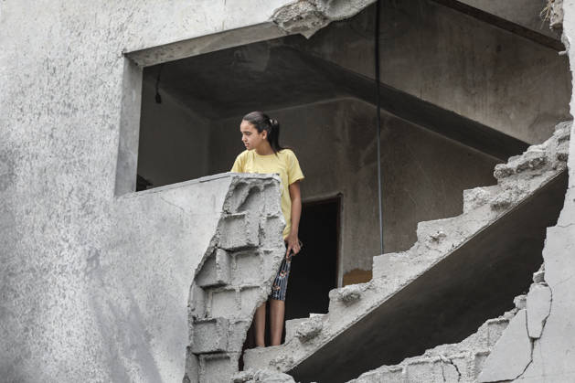 Israeli attack on Az-Zawayda area in Gaza DEIR AL-BALAH, GAZA, PALESTINE - OCTOBER 11: A girl stands on a damaged staircase inside a building following an Israeli airstrike targeting a building belonging to the Buheysi family in the town of Az-Zawayda, near Deir al-Balah in the central Gaza Strip, on October 11, 2026. Israeli forces carried out the strike despite the ceasefire, destroying the targeted building and damaging surrounding structures. Adam Bilal Anadolu Deir Al-Balah Gaza. Editorial use only. Please get in touch for any other usage.  Copyright: x2026xAnadoluxAdamxBilalx