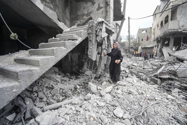 Israeli attack on Az-Zawayda area in Gaza DEIR AL-BALAH, GAZA, PALESTINE - OCTOBER 11: A woman stands amid the rubble near a damaged staircase following an Israeli airstrike targeting a building belonging to the Buheysi family in the town of Az-Zawayda, near Deir al-Balah in the central Gaza Strip, on October 11, 2026. Israeli forces carried out the strike despite the ceasefire, destroying the targeted building and damaging surrounding structures. Adam Bilal Anadolu Deir Al-Balah Gaza. Editorial use only. Please get in touch for any other usage.  Copyright: x2026xAnadoluxAdamxBilalx