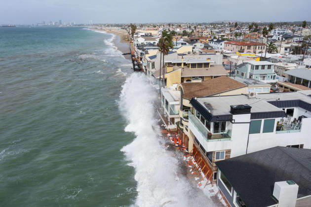 October 11, 2006, Long Beach, California, USA: The Long Beach Peninsula is facing severe, structural devastation as Tropical Storm Rachel batters the Southern California coast. Driven by a developing El Nino pattern, this is the fourth major storm system to slam the shoreline in six weeks. Waves and unusually high tides have shattered a 30-foot section of the protective wooden bulkhead, completely shredding the historic boardwalk and allowing seawater to surge directly onto interior streets. Flooding has swamped coastal neighborhoods, forcing mandatory evacuations along oceanfront blocks like Seaside Walk. Emergency crews are working to stack thousands of sandbags and reinforce coastal defenses, but city inspectors have already been forced - ZUMAr19_ 20261011_new_r19_129 Copyright: xRuaridhxStewartx