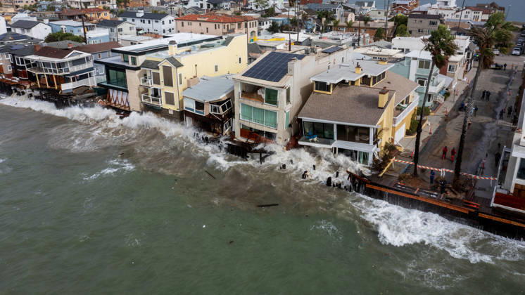 October 11, 2006, Long Beach, California, USA: The Long Beach Peninsula is facing severe, structural devastation as Tropical Storm Rachel batters the Southern California coast. Driven by a developing El Nino pattern, this is the fourth major storm system to slam the shoreline in six weeks. Waves and unusually high tides have shattered a 30-foot section of the protective wooden bulkhead, completely shredding the historic boardwalk and allowing seawater to surge directly onto interior streets. Flooding has swamped coastal neighborhoods, forcing mandatory evacuations along oceanfront blocks like Seaside Walk. Emergency crews are working to stack thousands of sandbags and reinforce coastal defenses, but city inspectors have already been forced - ZUMAr19_ 20261011_new_r19_130 Copyright: xRuaridhxStewartx