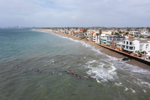 October 11, 2006, Long Beach, California, USA: The Long Beach Peninsula is facing severe, structural devastation as Tropical Storm Rachel batters the Southern California coast. Driven by a developing El Nino pattern, this is the fourth major storm system to slam the shoreline in six weeks. Waves and unusually high tides have shattered a 30-foot section of the protective wooden bulkhead, completely shredding the historic boardwalk and allowing seawater to surge directly onto interior streets. Flooding has swamped coastal neighborhoods, forcing mandatory evacuations along oceanfront blocks like Seaside Walk. Emergency crews are working to stack thousands of sandbags and reinforce coastal defenses, but city inspectors have already been forced - ZUMAr19_ 20261011_new_r19_139 Copyright: xRuaridhxStewartx