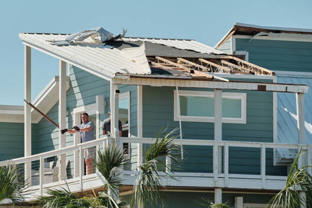 October 11, 2026, Pensacola Beach, Florida, U.S: October 11, 2026 Pensacola Beach, Florida USA: People throw out debris from the top of a storm damaged house after the arrival of Hurricane Isaias. Pensacola Beach U.S - ZUMAa14_ 20261011_zaf_a14_006 Copyright: xDanxAndersonx
