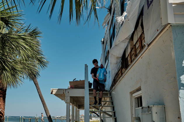 October 11, 2026, Pensacola Beach, Florida, U.S: October 11, 2026 Pensacola Beach, Florida USA: Alex Dean carries belonging out of his storm damaged apartment complex after the arrival of Hurricane Isaias. Pensacola Beach U.S - ZUMAa14_ 20261011_zaf_a14_007 Copyright: xDanxAndersonx