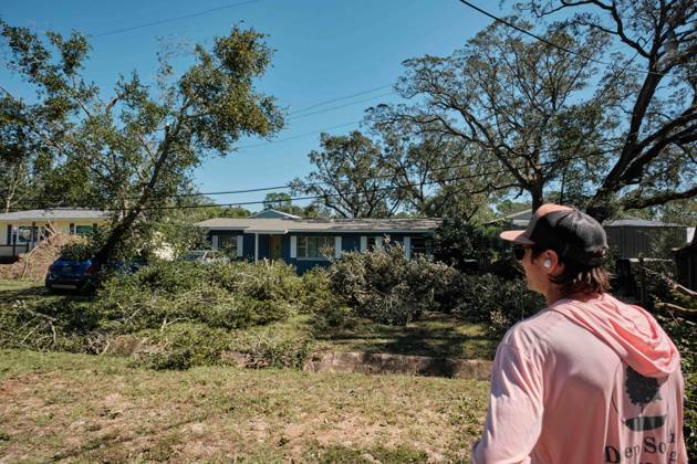 October 11, 2026, Pensacola, Florida, U.S: October 11, 2026 Pensacola, Florida USA: Jesse Roper of Deep South Landscaping looks at a yard full of fallen debris and branches after the arrival of Hurricane Isaias. Pensacola U.S - ZUMAa14_ 20261011_zaf_a14_022 Copyright: xDanxAndersonx