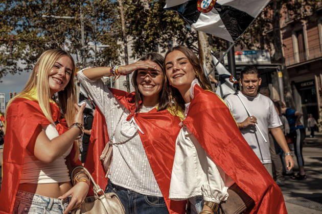 October 12, 2026, Barcelona, Catalonia, Spain: Three women wrapped in Spanish flags pose beneath a flag of Ceuta during a demonstration marking SpainÃ¢â‚¬â ¢s National Day. Barcelona Spain - ZUMAo105 20261012_fap_o105_002 Copyright: xMatthiasxOesterlex