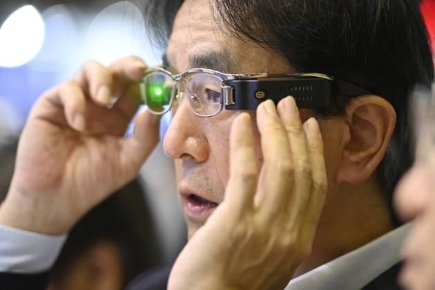Japan showcases emerging technologies at CEATEC 2026 CHIBA, JAPAN - OCTOBER 13: A visitor tries on a prototype of smart glasses featuring Meta-Optic Mirror technology developed by Japanese electronics company TDK during CEATEC 2026 at Makuhari Messe in Chiba, Japan, October 13, 2026. The prototype uses an ultra-thin optical mirror to direct projected images onto the retina, with TDK aiming to develop more compact and conventional-looking smart glasses. David Mareuil Anadolu Chiba Japan. Editorial use only. Please get in touch for any other usage.  Copyright: x2026xAnadoluxDavidxMareuilx
