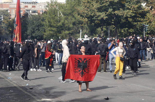 Protesters Clash with Police During a Demonstration in Tirana, Albania. Protesters hold an Albanian flag as they throw stones to riot police during an anti-government demonstration in central Tirana on October 15, 2026, as protests continued for a third consecutive day over university conditions and demands for the resignation of Albanian Prime Minister Edi Rama. The latest rally follows two nights of violence in the capital, during which protesters and riot police clashed, police used water cannons and tear gas, and demonstrators damaged government offices and shops and set fire to several buildings. Light Studio Agency Malton Dibra Tirana Albania Copyright: xLightxStudioxAgencyx xMaltonxDibrax