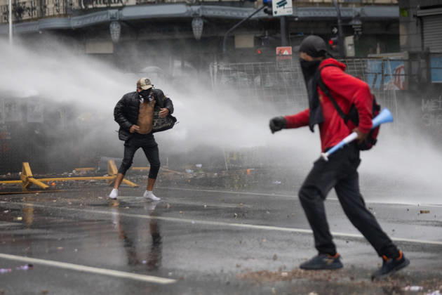October 16, 2026, Buenos Aires, Buenos Aires, Argentina: Protesters flee water sprayed from police water cannon trucks during clashes with police. Buenos Aires Argentina  - ZUMAp265 20261016_zip_p265_048 Copyright: xDelfinaxCorberaxPix