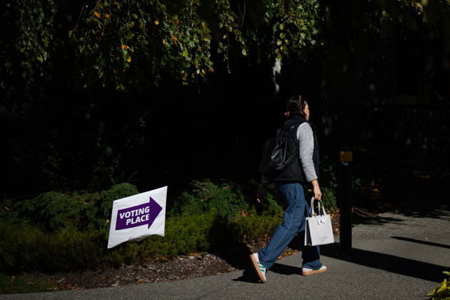 October 17, 2026, Port Moody, Bc, CANADA: A woman walks past a sign directing people to a polling station in Vancouver, on Saturday Oct. 17, 2026. British Columbians are heading to the polls to cast their votes in municipal elections being held across the province. Port Moody CANADA  - ZUMAc35_ 20261017_zaf_c35_019 Copyright: xEthanxCairnsx
