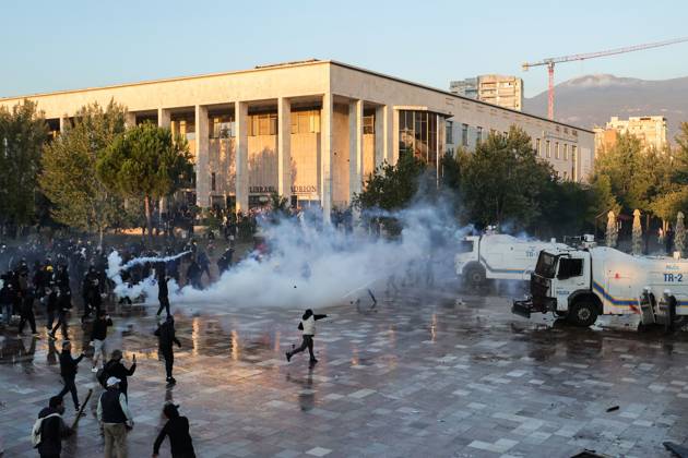 October 18, 2026, Tirana, Albania: TIRANA, ALBANIA, OCTOBER 18, 2026: Demonstrators clash with riot police in Skanderbeg Square as student-led anti-government protests continue for a sixth consecutive day. Confrontations spread from the Ministry of Education to central Tirana, with protesters throwing stones and pyrotechnics while police deploy tear gas and water cannons. Demonstrators demand improved university conditions and the resignation of Prime Minister Edi Rama. Tirana Albania - ZUMAq101 20261018_zna_q101_221 Copyright: xVlasovxSulajx