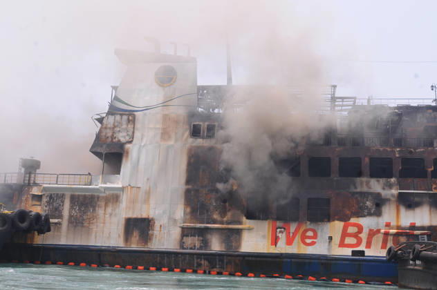 Efforts are underway to extinguish a fire that broke out on a passenger ferry in Indonesia s Cilegon PELABUHAN MERAK, CILEGON, INDONESIA - OCTOBER 21: Fireboats take turns spraying water onto the passenger ferry KMP Batumandi to cool down the vessel after it caught fire while preparing to dock off Merak Port in Cilegon, Banten, Indonesia on Wednesday, October 21, 2026. The vessel caught fire on Tuesday, October 20, and rescue operations remain underway as the ship continues to emit smoke. Water is continuously sprayed to cool the vehicle deck containing numerous cars, motorcycles, buses, and trucks, while authorities confirm no fatalities have been reported. Dasril Roszandi Anadolu Pelabuhan Merak Indonesia. Editorial use only. Please get  Copyright: x2026xAnadoluxDasrilxRoszandix