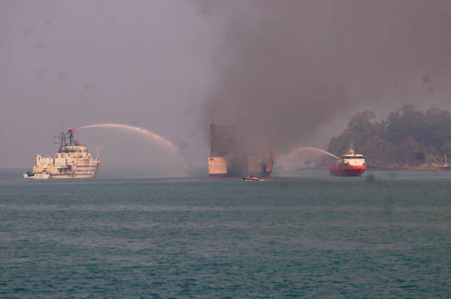 Efforts are underway to extinguish a fire that broke out on a passenger ferry in Indonesia s Cilegon PELABUHAN MERAK, CILEGON, INDONESIA - OCTOBER 21: Fireboats take turns spraying water onto the passenger ferry KMP Batumandi to cool down the vessel after it caught fire while preparing to dock off Merak Port in Cilegon, Banten, Indonesia on Wednesday, October 21, 2026. The vessel caught fire on Tuesday, October 20, and rescue operations remain underway as the ship continues to emit smoke. Water is continuously sprayed to cool the vehicle deck containing numerous cars, motorcycles, buses, and trucks, while authorities confirm no fatalities have been reported. Dasril Roszandi Anadolu Pelabuhan Merak Indonesia. Editorial use only. Please get  Copyright: x2026xAnadoluxDasrilxRoszandix